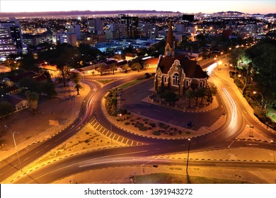 Windhoek,Namibia.April 2019.The Christ Church Or Christuskirche Is A Historic Lutheran Church.It Was Designed By Architect Gottlieb Redecker,dedicated In 1910 .Arial City View Of Windhoek At Night.