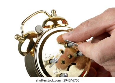 Winding Up A Alarm Clock Isolated On A White Background