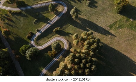 A Winding Bike Path In A City Park. Aerial Photography At Sunset.