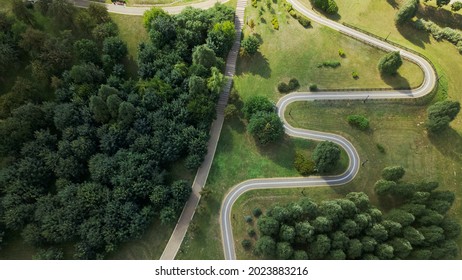 A winding bike path in the park. Winds among trees and bushes. Aerial photography. - Powered by Shutterstock