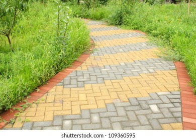 A Winding Brick Path In A Garden