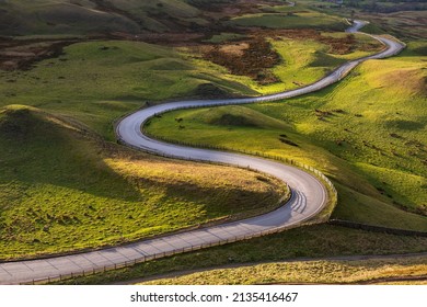 Winding Curvy Rural Road Leading Through British Countryside In The Peak District, UK.