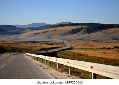 Winding Curvy Rural Road Through Sunlit Mountains In Bosnia