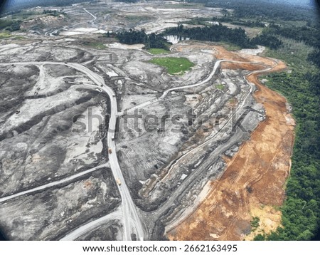 Winding Mining Roads Cutting Through Exposed Earth Layers in South Kalimantan