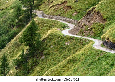 Winding Mountain Path On A Green Meadow