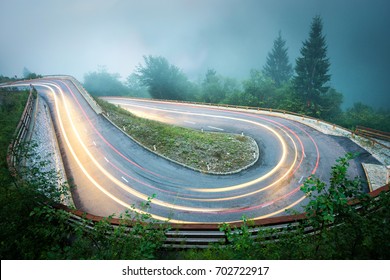 Winding Mountain Road With Car Lights. Foggy Wet Weather And Low Visibility. Alps, Slovenia.