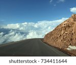 Winding Mountain Road With Clouds