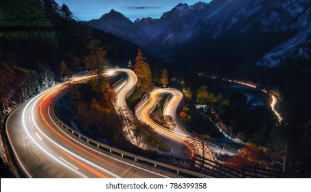 The winding mountain road at the night with light tracks from cars, Maloja Pass, Switzerland - Powered by Shutterstock