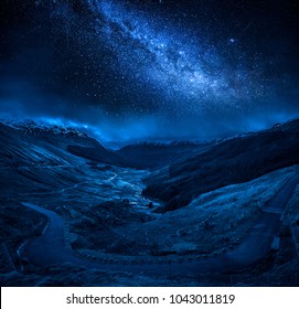 Winding Mountain Road Over A Canyon At Night With Stars