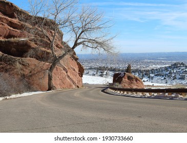 A Winding Mountain Road Surrounded By Red Rock That Leads To Red Rock Amphitheater Near Denver, Colorado.