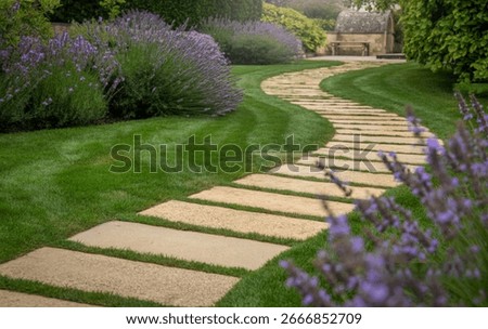 A winding path of large, light-colored stone pavers leads through a vibrant green lawn. Blooming lavender bushes flank the path, creating a serene and picturesque garden scene.
