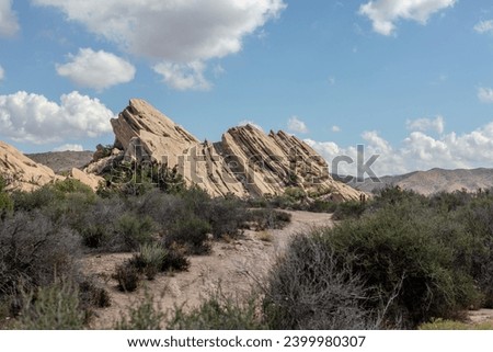 A winding path leads to the iconic Vasquez Rocks in Santa Clarita, California. Embark on an outdoor adventure, traverse the rocky landscape, and discover the scenic beauty of this renowned landmark.