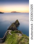 A winding path on Dingle Peninsula leads to cliffs above the ocean