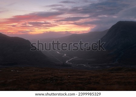 A winding river between mountain ranges illuminated by the rising sun. A82 road opposite Buachaille Etive Mor at dawn. Scotland Stock photo © 