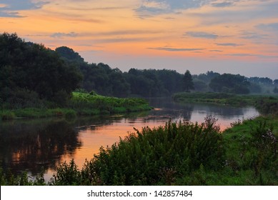 winding river reflects sunset sky