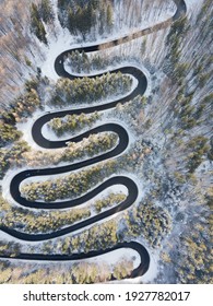 Winding Road Aerial View By Drone. Brasov, Romania. There Are Huge Snow Mountains And Long Winding Road In This Area. This Is A Great Place To Drive And Stop During A Road Trip.