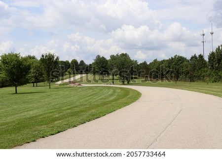 Similar – Image, Stock Photo Winding country road with dust cloud through the forest at sunrise. Spring landscape.