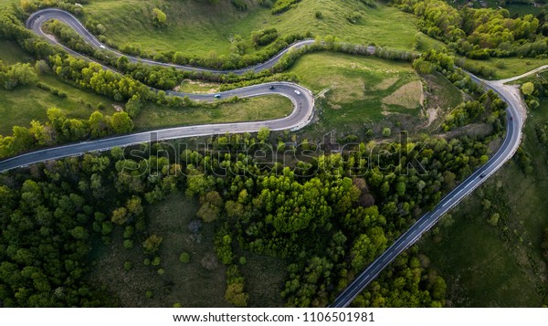 Winding road from high mountain pass, in\
spring time. Aerial view by drone .\
Romania	