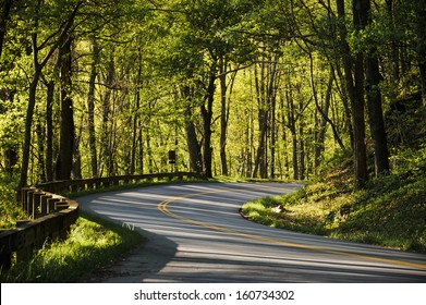 a winding road in the mountains early in the morning