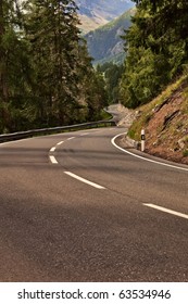 Winding Road In Mountains With Pinetrees On Both Sides.