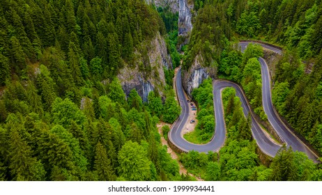 Winding Road In The Mountains, Shot From A Drone From A Lower Altitude And A Low Camera Angle. Photography Of A Serpentine Road In The Mountains.