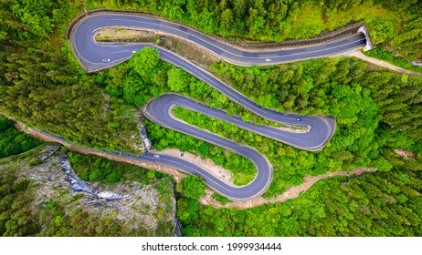 Winding Road In The Mountains, Shot From A Drone From A Higher Altitude And A Low Camera Angle. Photography Of A Serpentine Road In The Mountains.