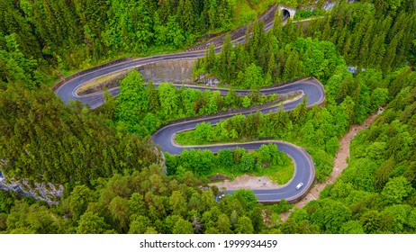 Winding Road In The Mountains, Shot From A Drone From A Lower Altitude And A Low Camera Angle. Photography Of A Serpentine Road In The Mountains.