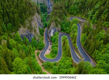 Winding Road In The Mountains, Shot From A Drone From A Lower Altitude And A Low Camera Angle. Photography Of A Serpentine Road In The Mountains.