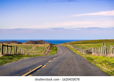 Winding road on the Pacific Ocean coastline on a clear sunny day, Point Reyes National Seashore, California