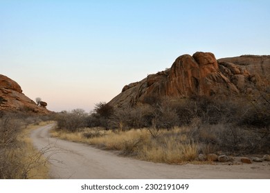 Winding road in perspective between stone blocks in the desert. Drought and dehydration. - Powered by Shutterstock