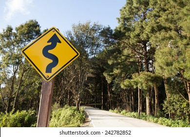 Winding Road Sign,yellow Winding Road Ahead Sign In Pine Wood Mountain Street