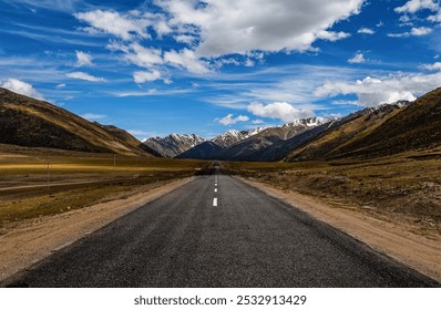 A winding road stretches towards distant snow-capped peaks, flanked by green hills under a vibrant sky dotted with fluffy clouds. - Powered by Shutterstock