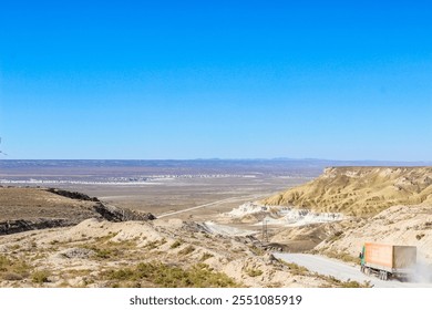 Winding road through dramatic desert canyon landscape with cargo truck - Powered by Shutterstock