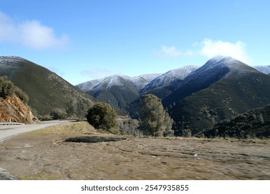 Winding Road Through Snow-Capped Mountains - Powered by Shutterstock