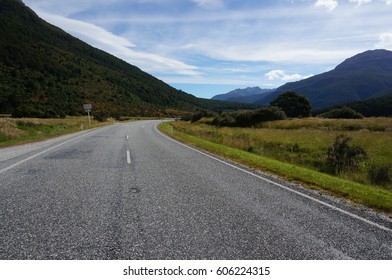 Winding Road through the wilderness with mountains either side, New Zealand