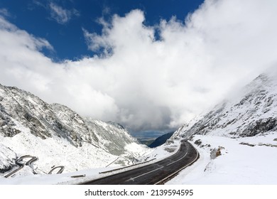 Winding road transfagarasan, mountain valley and the tops of the mountains covered with snow. Winter landscape of a mountainous area in sunny weather. Location Carpathians of Romania, Transylvania.