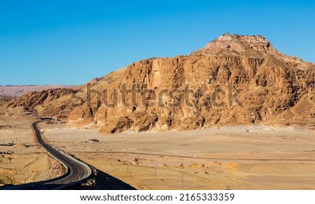 Winding road in the valley in Sinai mountains, beautiful landscape of the mountains, orange sand of Sinai. South Sinai, Sinai peninsula, Egypt