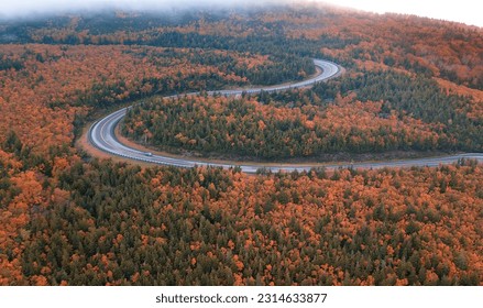Winding roads of the world famous Cabot Trail, Cape Breton Highlands in the peak autumn fall season with mixed color deciduous trees.