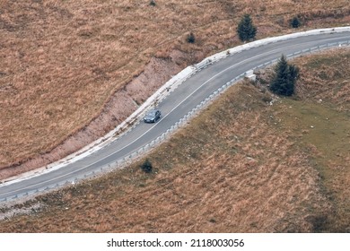 Winding Serpenine Road In The Mountains With A Single Lonely Car. Color Lanscape Photo.