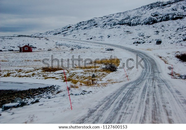 Winding street during icy and cold\
winter time can be dangerous for vehicles and\
cars.