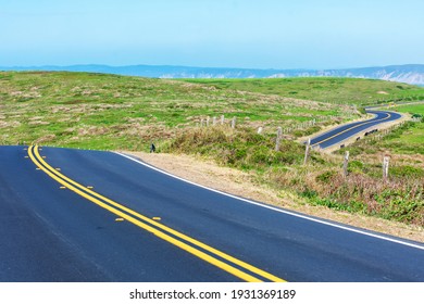 Winding two lane road on scenic Pacific Ocean coastline on a clear sunny day at Point Reyes National Seashore, California