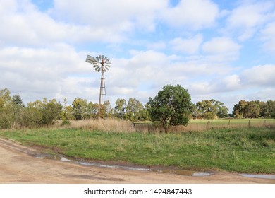 Windmill In A Cloudy Sky Rural Australian Landscape