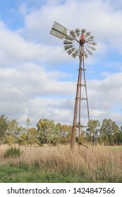 Windmill In A Cloudy Sky Rural Australian Landscape