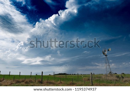 Windmill in the countryside and the storm arriving