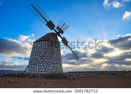 Windmill during dramatic sunset with colorful sky