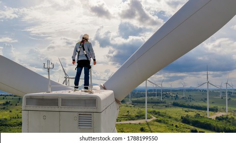 Windmill Engineer Wearing PPE Standing On Wind Turbine