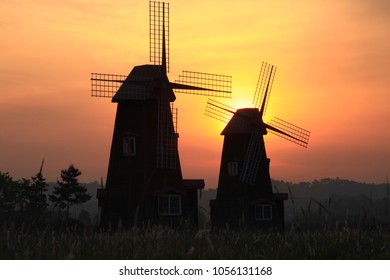windmill in the field sun set