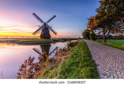 Windmill in Holland. Mill by the river at dawn. Windmill at dawn - Shutterstock ID 2168458337