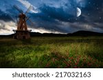 Windmill in the night. Elements of this image furnished by NASA.