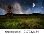 Windmill in the night. Elements of this image furnished by NASA.